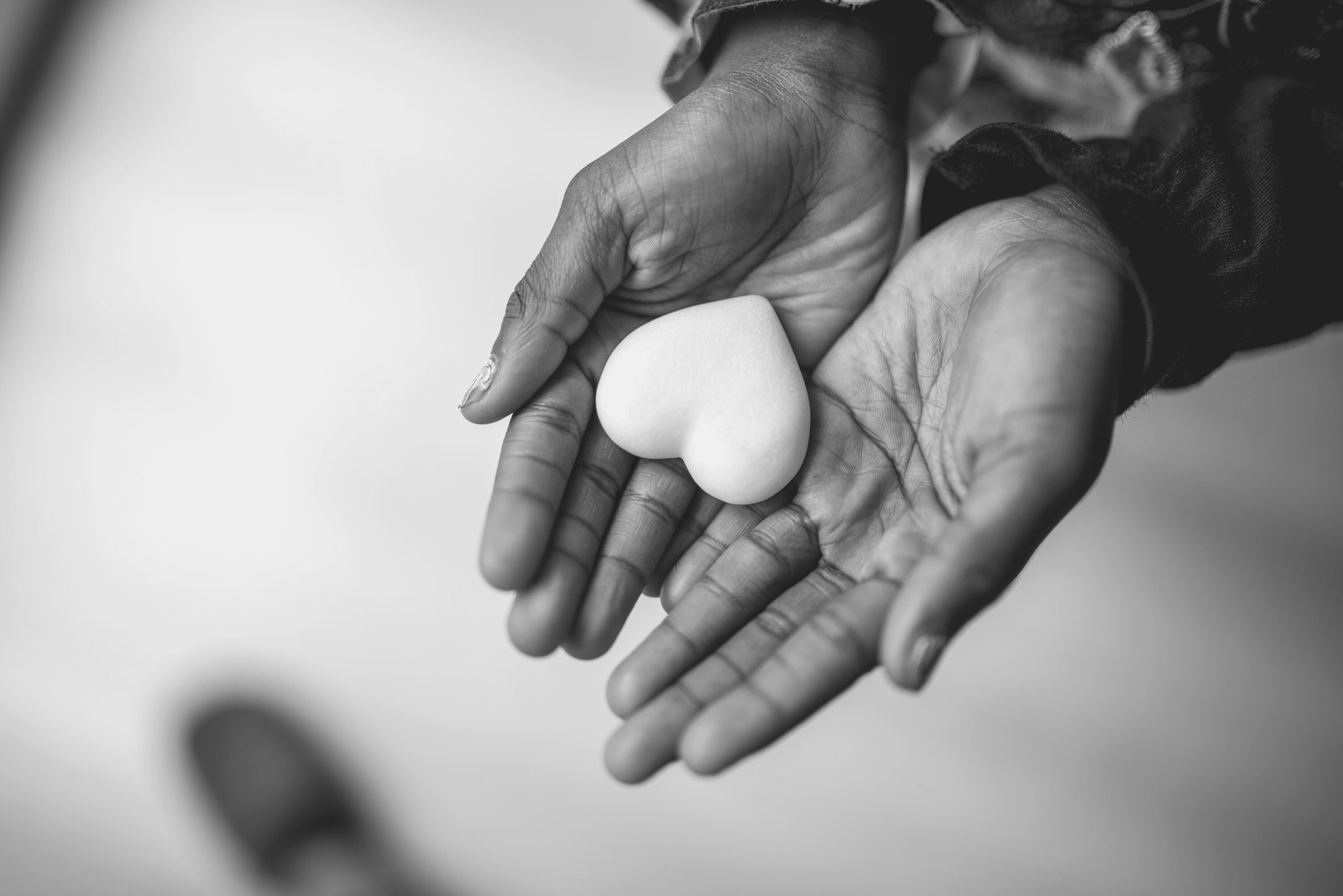 Hands cradling in black and white, a symbol of care